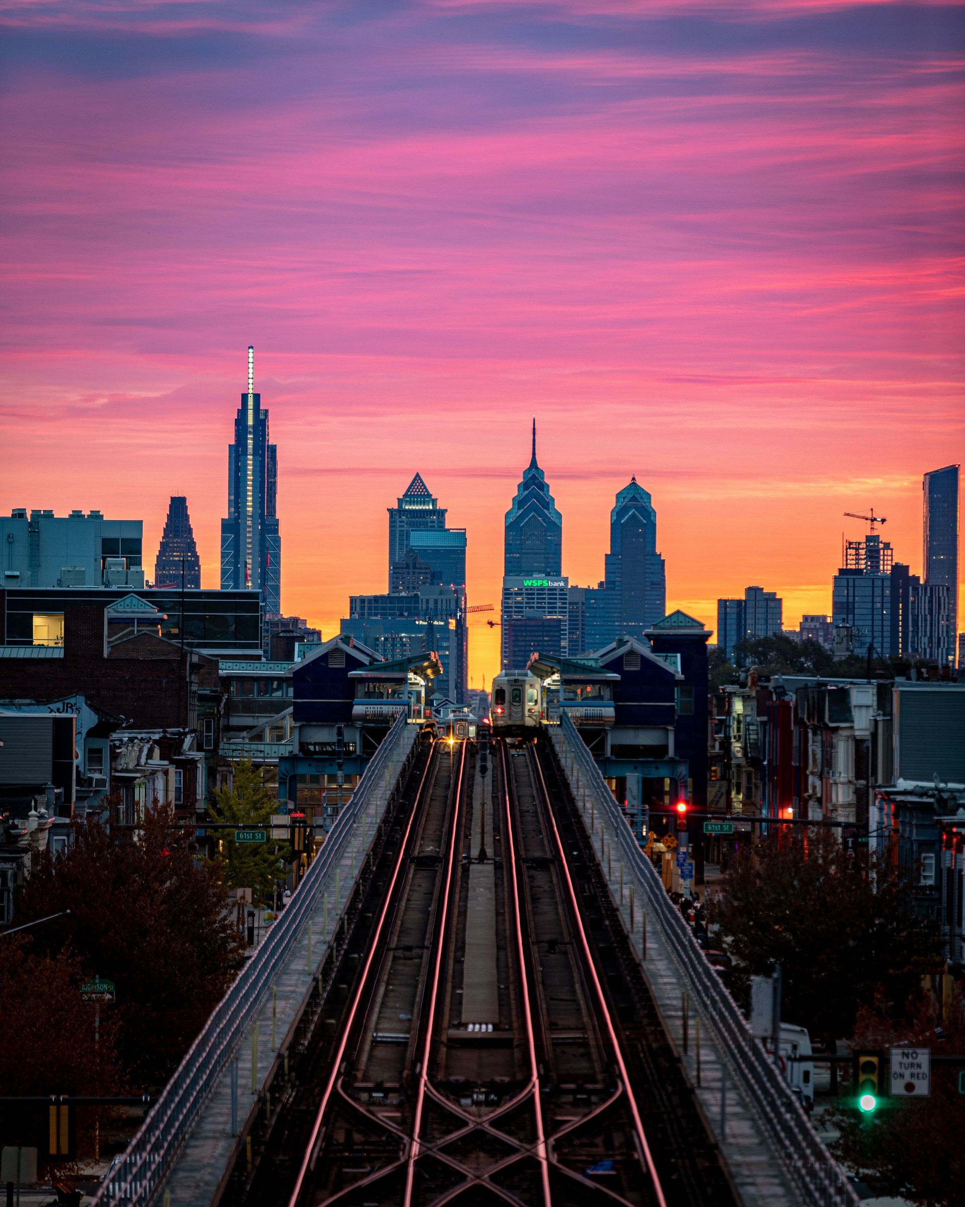 Aerial view of Benjamin Franklin Bridge and Philadelphia skyline on colorful sunset sky background